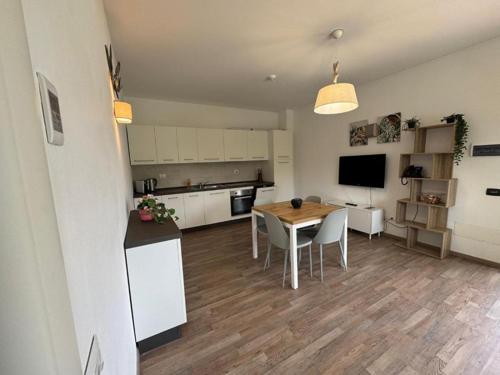 a kitchen and living room with a table and chairs at Residence San Francesco in Tirrenia