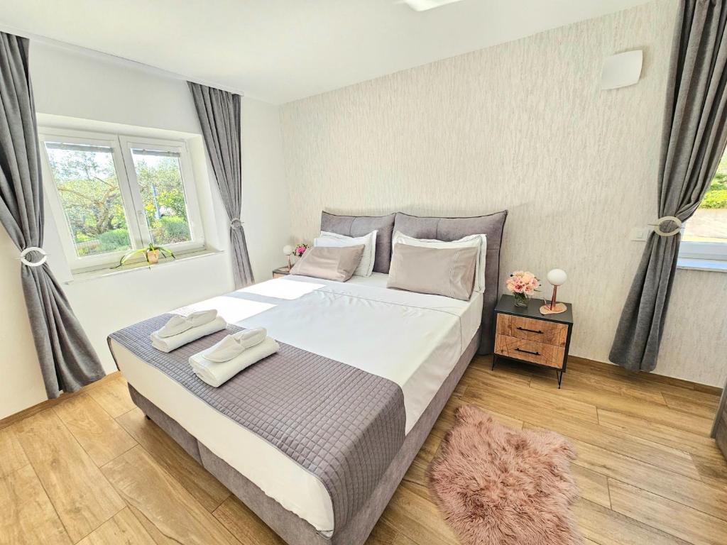 a bedroom with a large bed and a window at New Istrian Experience by Istrian apartments Koper in Koper