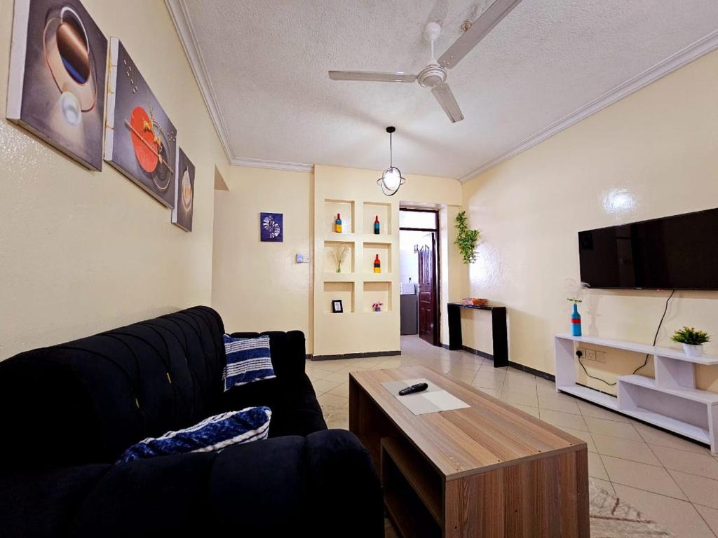 a living room with a couch and a coffee table at Two bedroom apartment, Mombasa CBD in Mombasa