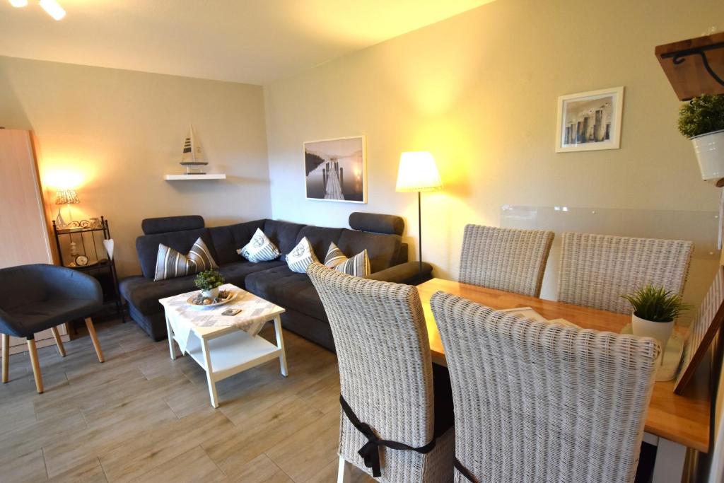 a living room with a couch and a table at FeWo Sol Mare Whg2 in Kellenhusen