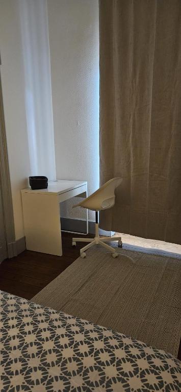 - un bureau blanc et une chaise dans la chambre dans l'établissement Appartement de charme Proche Matabiau capitole très calme, à Toulouse