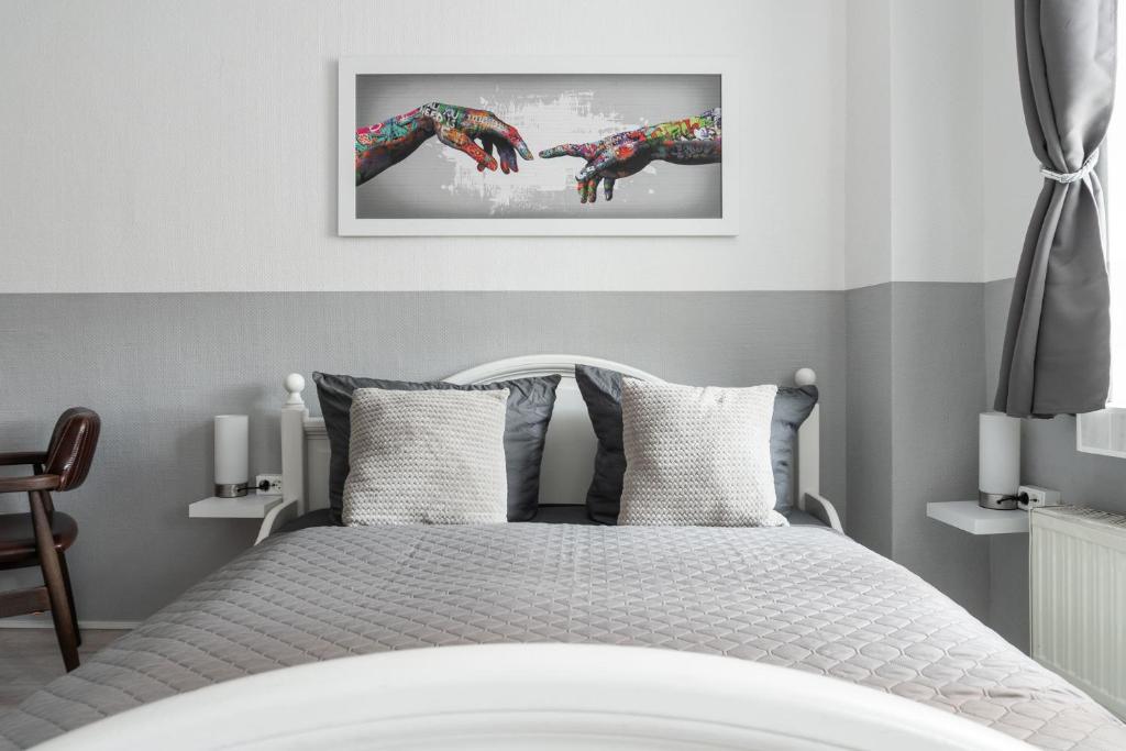 a bedroom with a bed with two hands reaching out at SchaeBu! 3 Apartment Altmarkt in neuem Glanz in Cottbus