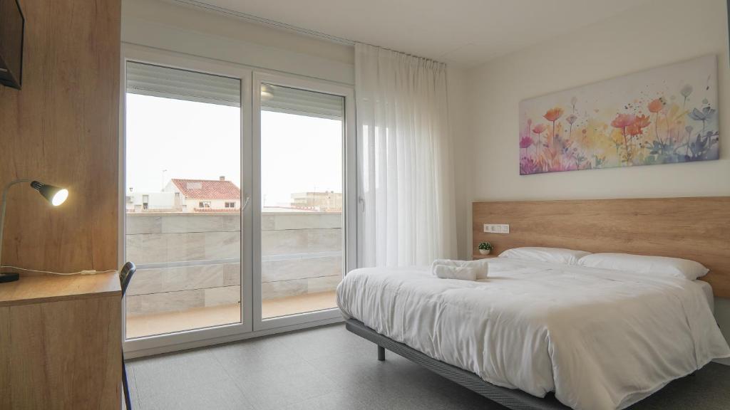 Postel nebo postele na pokoji v ubytování Hostal Calaya