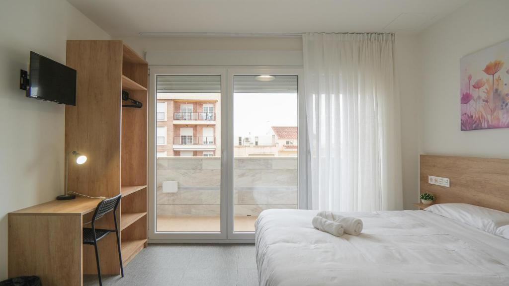 Postel nebo postele na pokoji v ubytování Hostal Calaya