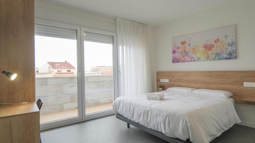 Postel nebo postele na pokoji v ubytování Hostal Calaya