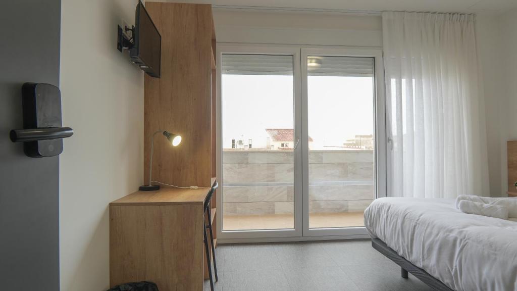 Postel nebo postele na pokoji v ubytování Hostal Calaya