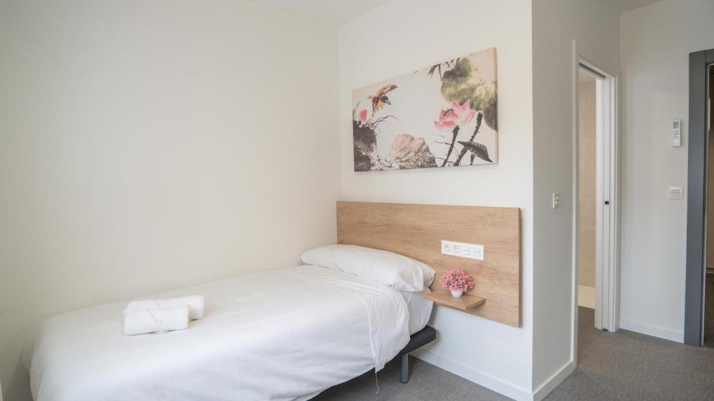 Postel nebo postele na pokoji v ubytování Hostal Calaya