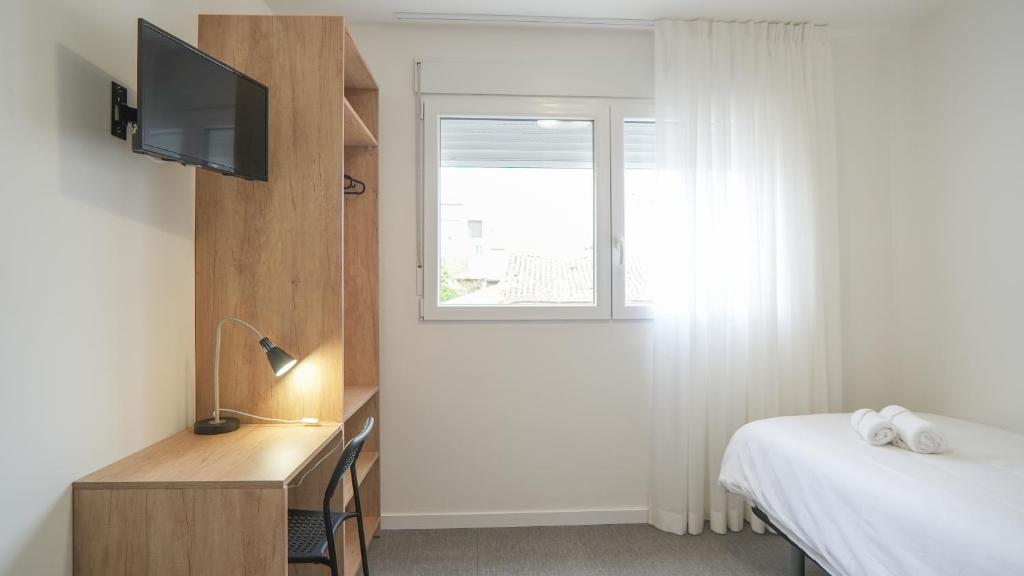 Postel nebo postele na pokoji v ubytování Hostal Calaya