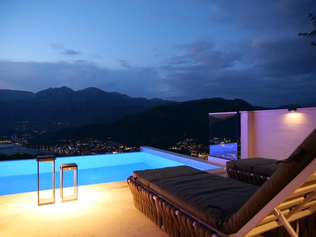 a swimming pool with a view of the mountains at Boka View House Luxury Sea View Villa in Luštica Bay in Luštica