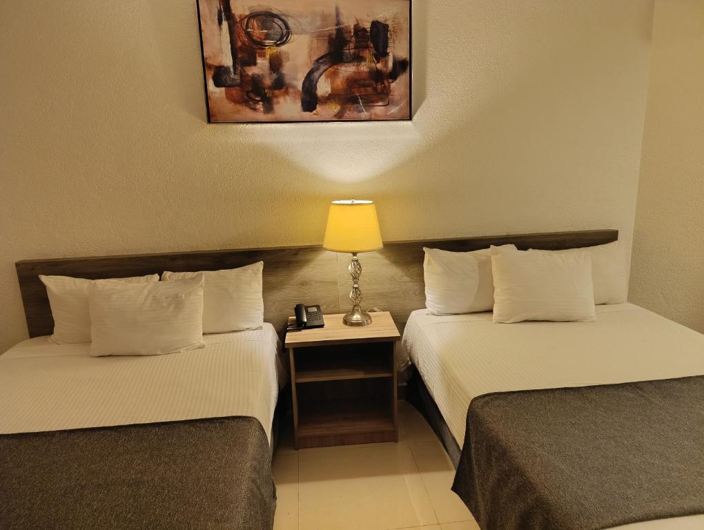 Postel nebo postele na pokoji v ubytování Hotel Laffayette Ejecutivo