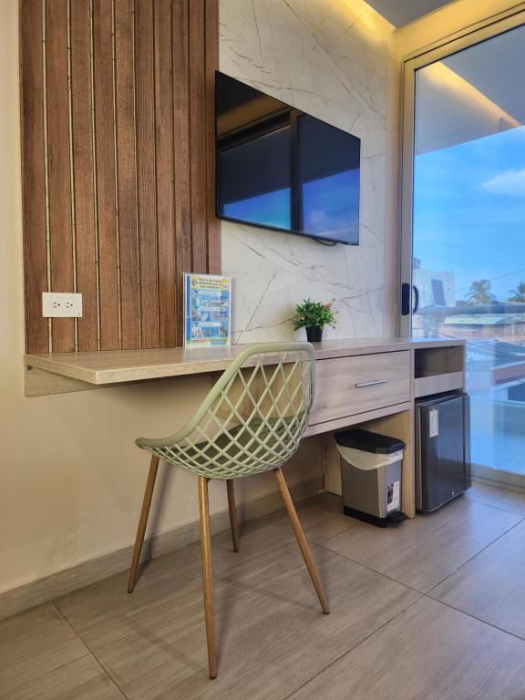 TV a/nebo společenská místnost v ubytování Hotel y Cabañas Covemar