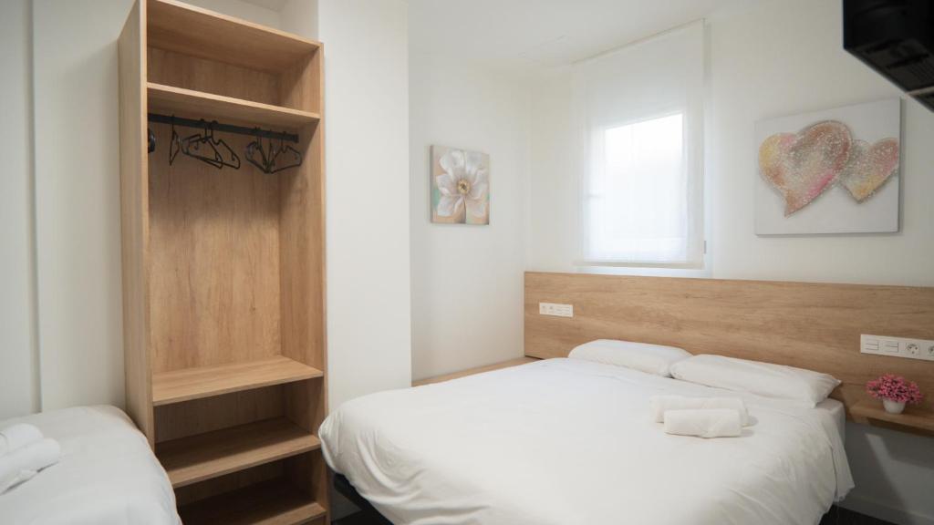 Postel nebo postele na pokoji v ubytování Hostal Calaya