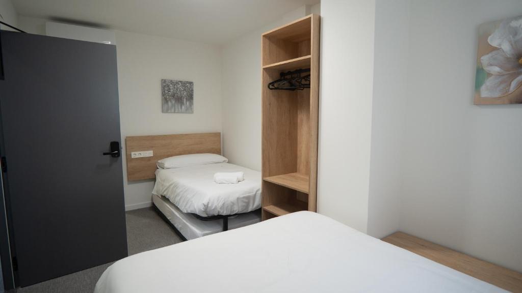 Postel nebo postele na pokoji v ubytování Hostal Calaya