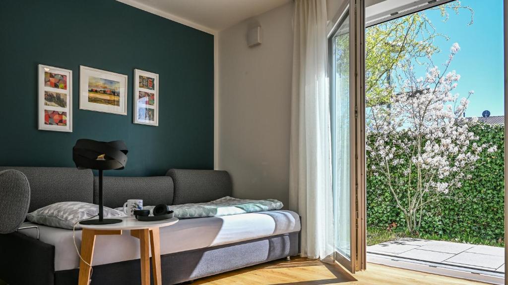 a living room with a bed and a table at Apartment mit überdachter Terrasse 7 7 EG in Friedrichshafen