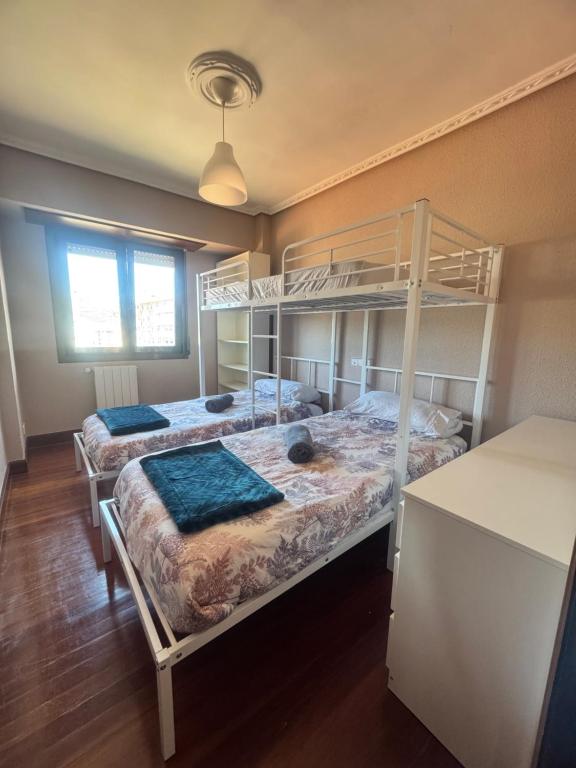 a bedroom with two bunk beds and a window at Muskiz Retreat, playa 5 mins, WIFI gratis in Muskiz