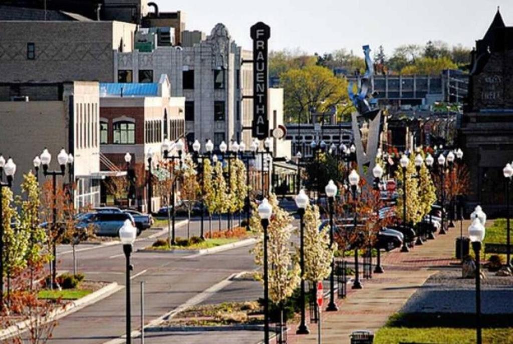 a street with many street lights on a sidewalk at Bluffton Breeze Cottage in Muskegon