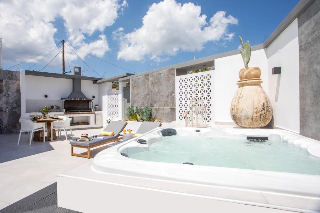 a large bath tub in the middle of a patio at Chrispa Villa in Afantou