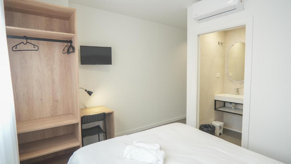Postel nebo postele na pokoji v ubytování Hostal Calaya