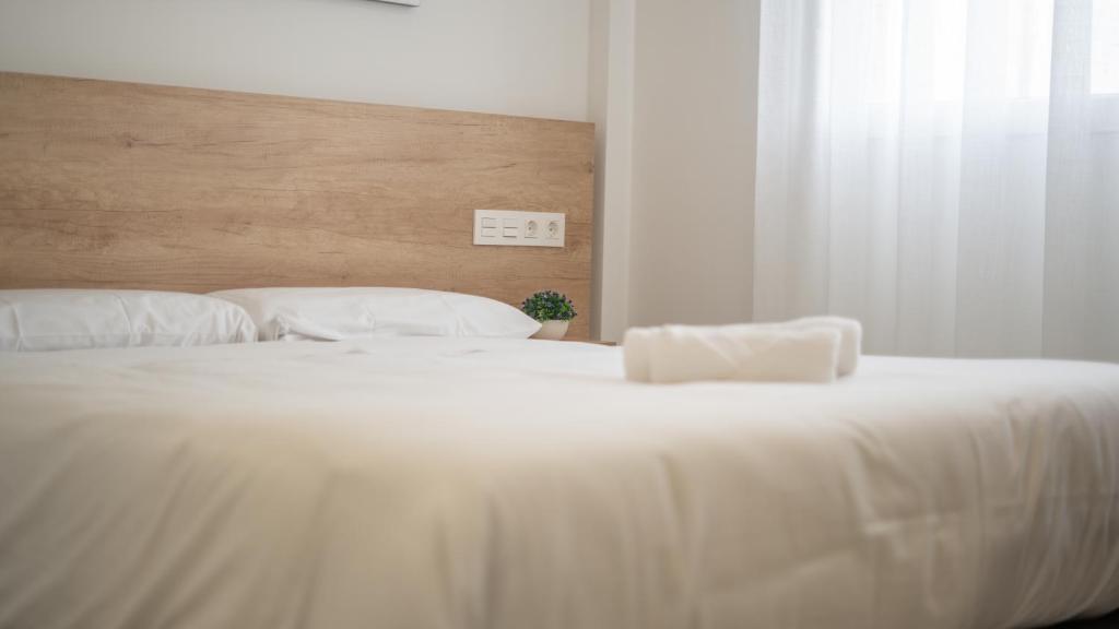 Postel nebo postele na pokoji v ubytování Hostal Calaya