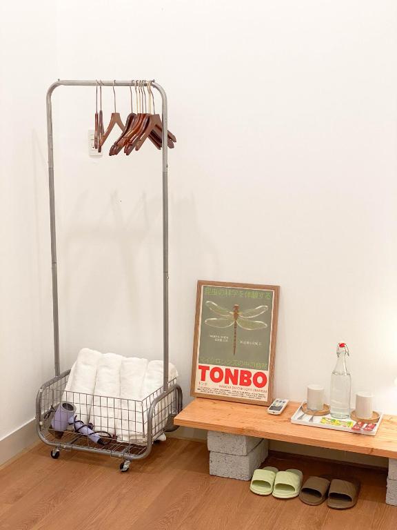 a room with a table and a cart with towels at Chiri Homestay in Thôn Trường Giang