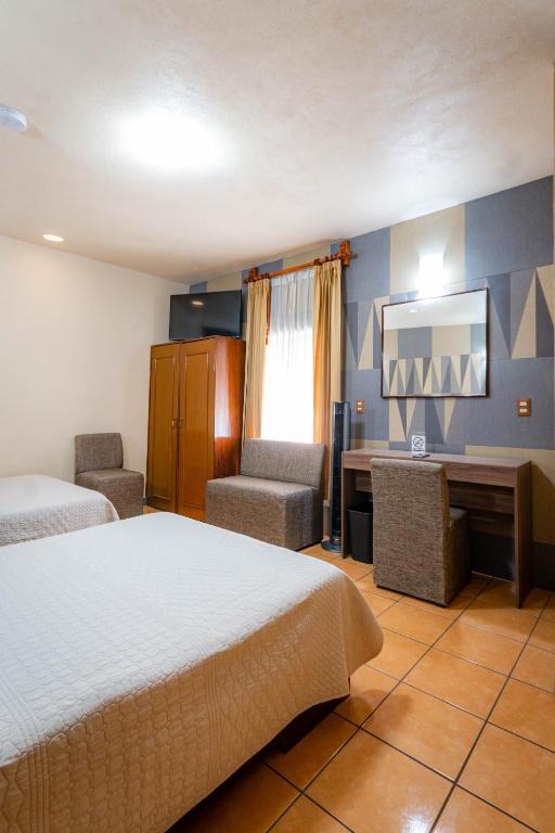 Postel nebo postele na pokoji v ubytování Hotel Estefania