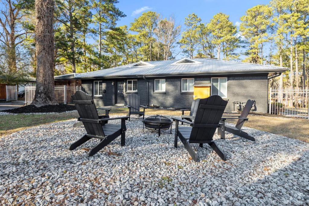 a group of chairs and a table in front of a tiny house at East Atlanta Retreat with 2 Homes Sleeps 16 and Pet Friendly in Decatur