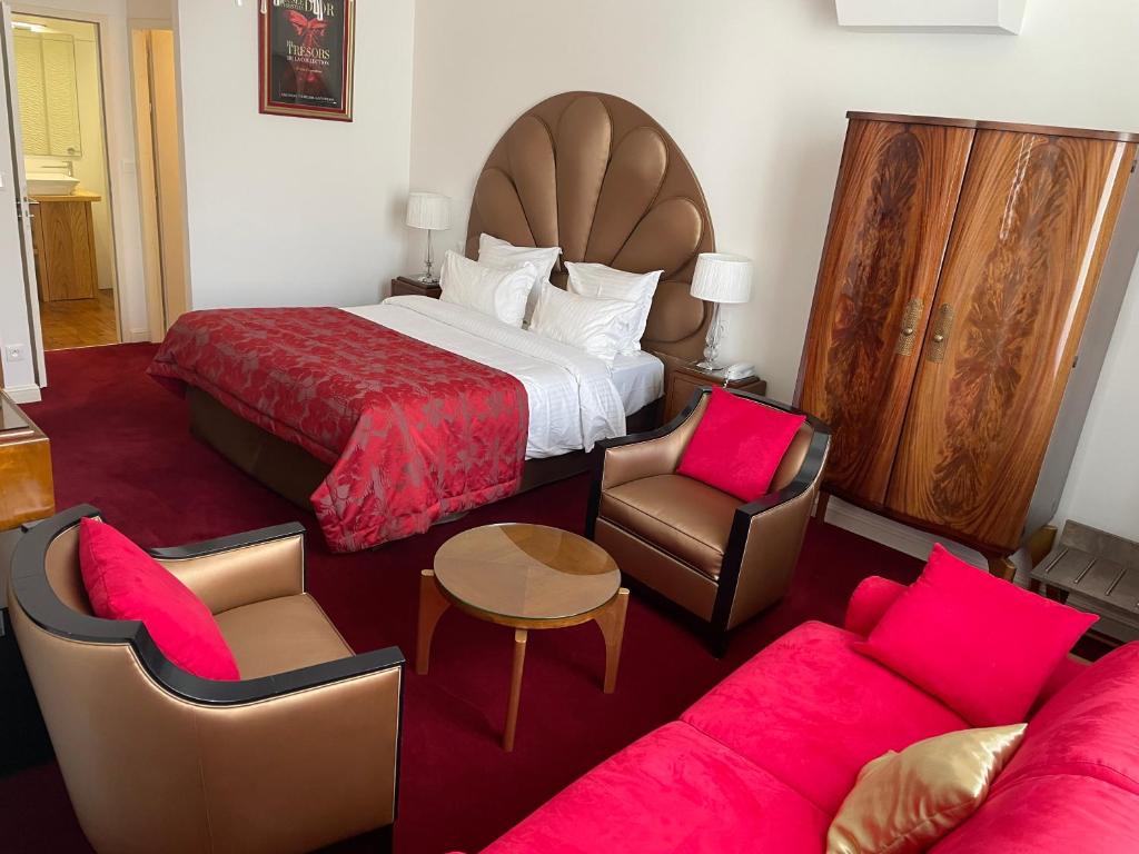Postel nebo postele na pokoji v ubytování Hôtel Victor Hugo