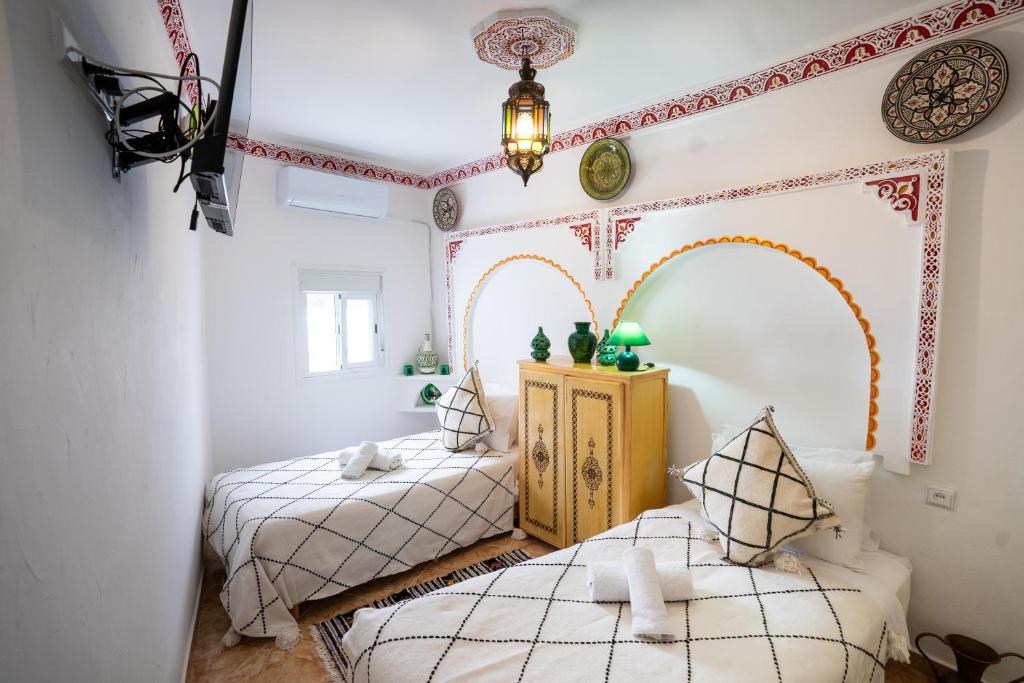 Postel nebo postele na pokoji v ubytování Dar AL BARAKA
