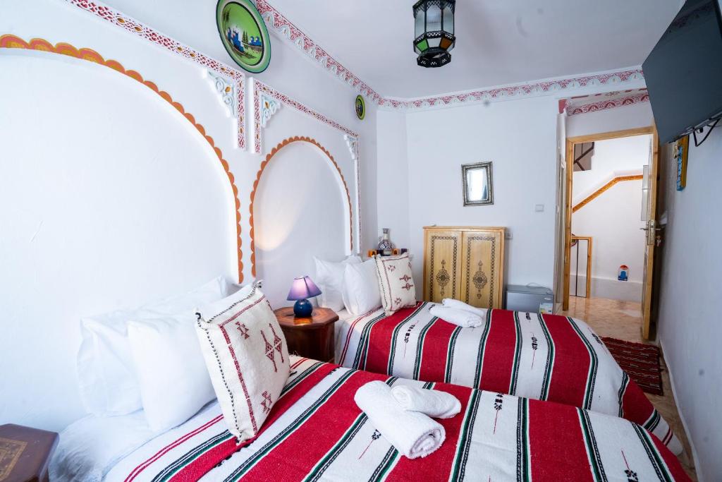 Postel nebo postele na pokoji v ubytování Dar AL BARAKA