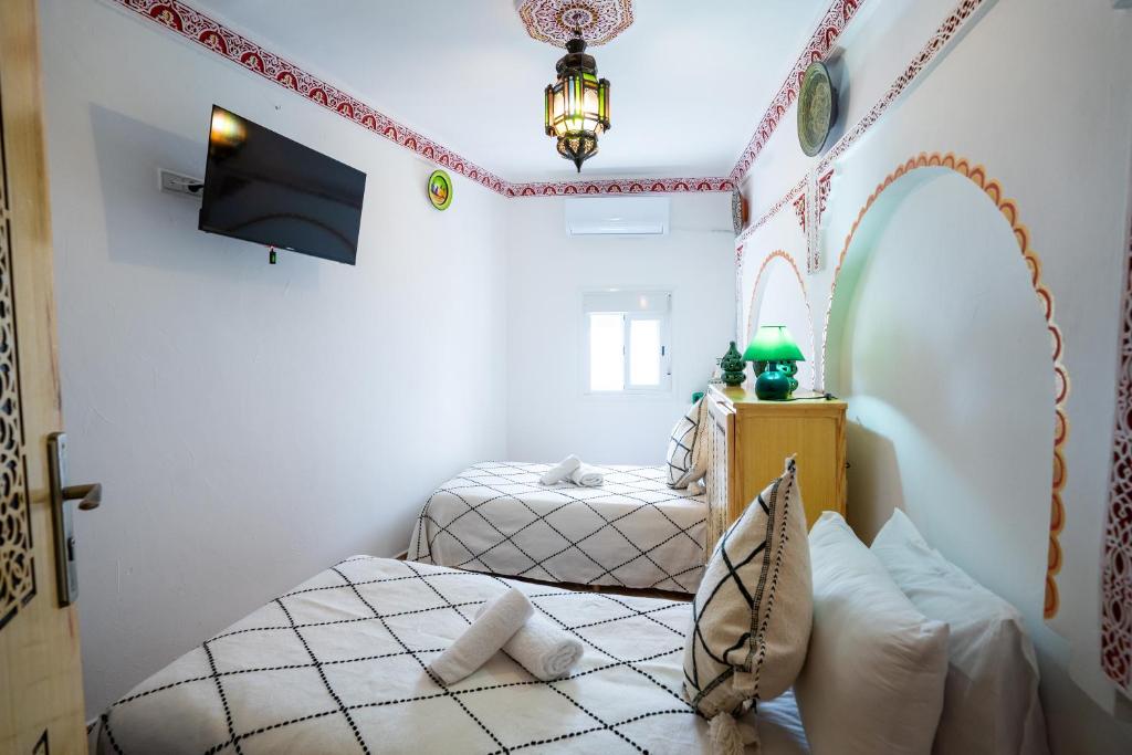 Postel nebo postele na pokoji v ubytování Dar AL BARAKA