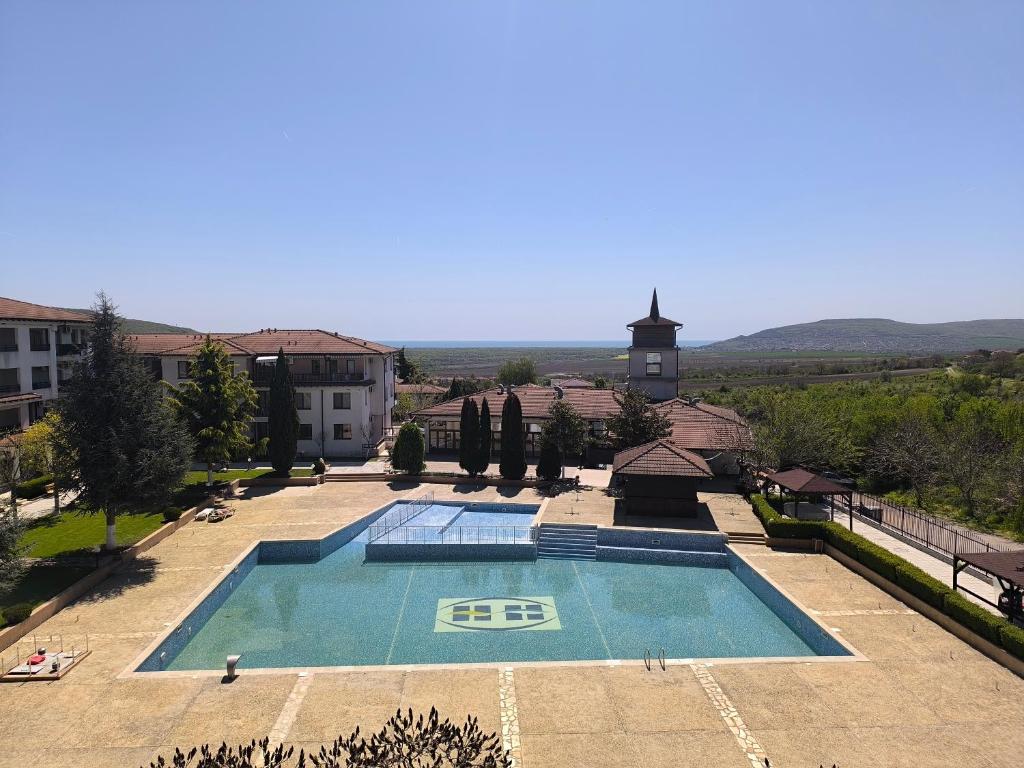 a large swimming pool in front of a building at Daisy Studios Harmony Hills in Rogachevo