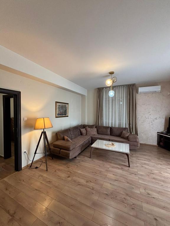a living room with a couch and a table at Enjoy 1 Apartmani in Podgorica