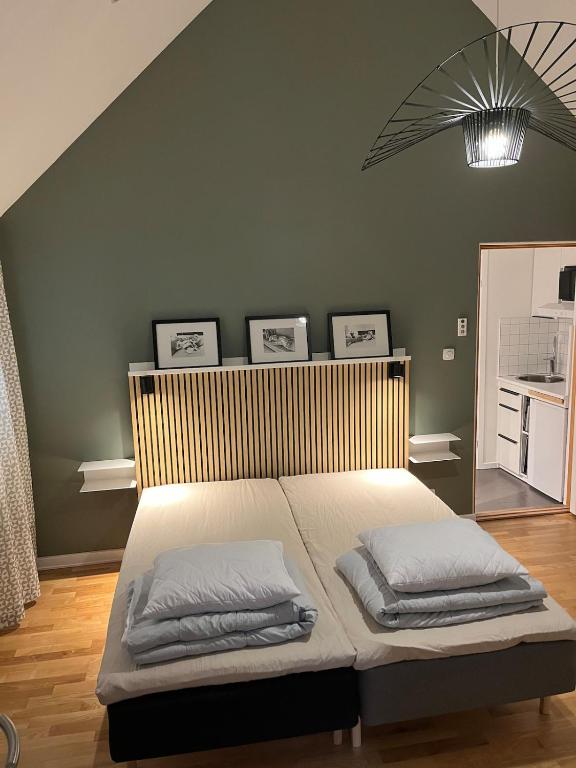 a bedroom with a bed with three pillows on it at Studio in Tygelsjö in Tygelsjö