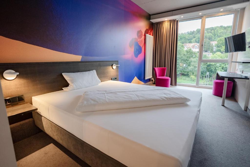 Postel nebo postele na pokoji v ubytování qubixx stadtmittehotel