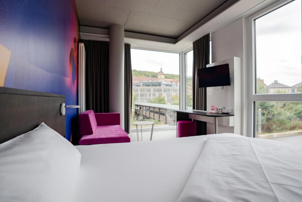 Postel nebo postele na pokoji v ubytování qubixx stadtmittehotel