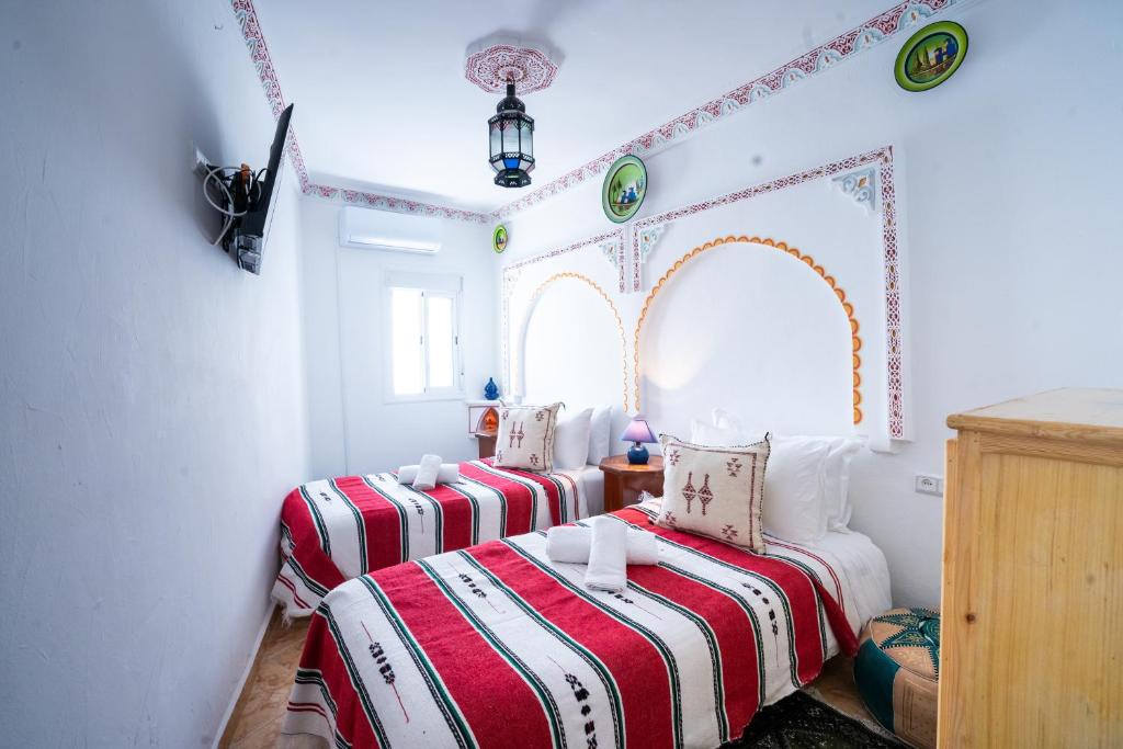 Postel nebo postele na pokoji v ubytování Dar AL BARAKA