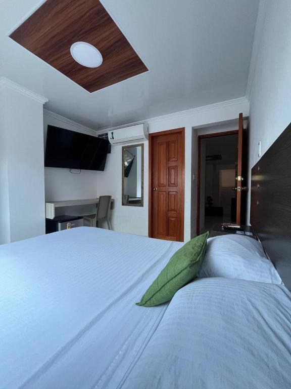 Postel nebo postele na pokoji v ubytování Villa Santos Apartaestudios