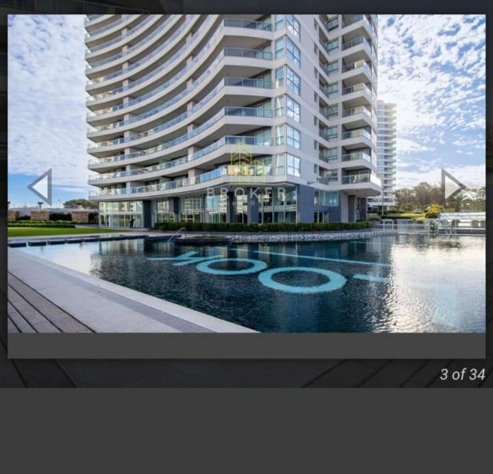 a large apartment building with a swimming pool in front of it at Look Brava in Punta del Este