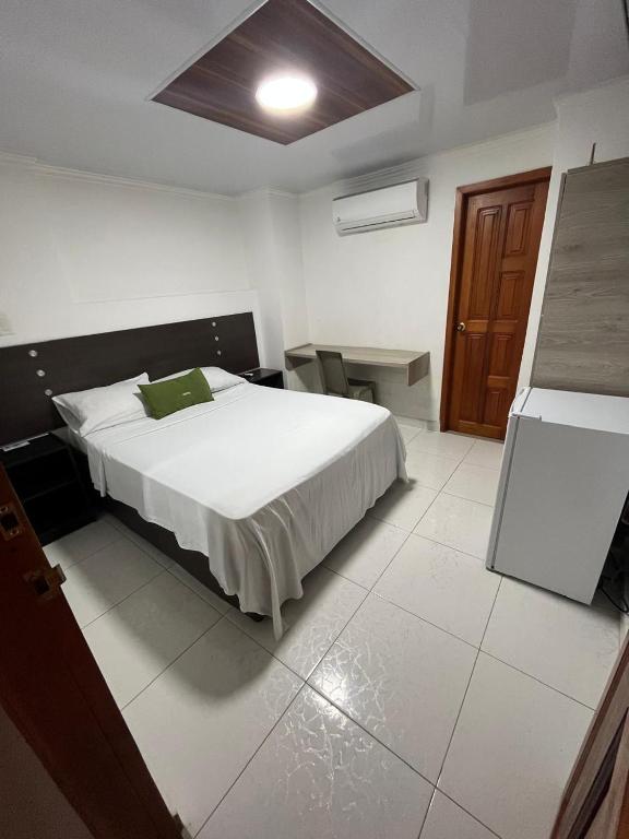 Postel nebo postele na pokoji v ubytování Villa Santos Apartaestudios
