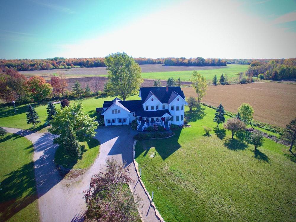 an aerial view of a large house on a field at Twin Peaks B&B in Mindemoya