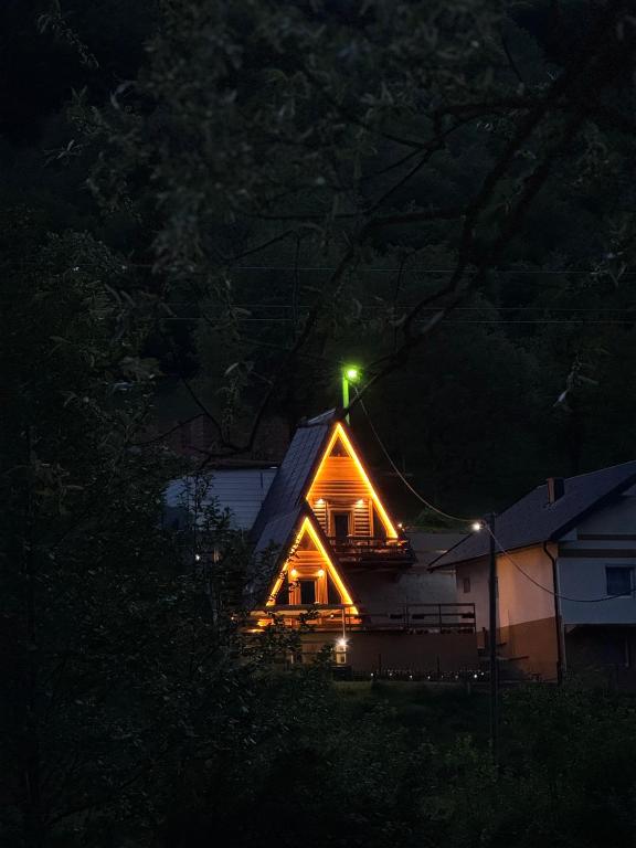a house with a light on the roof at night at Dream House Una in Orašac