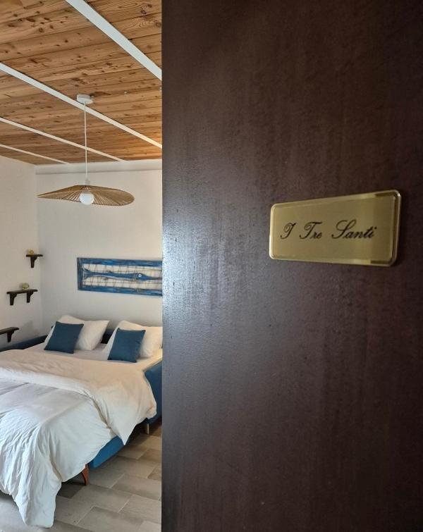a bedroom with two beds and a sign on the wall at Appartamento I TRE SANTI in Bisceglie