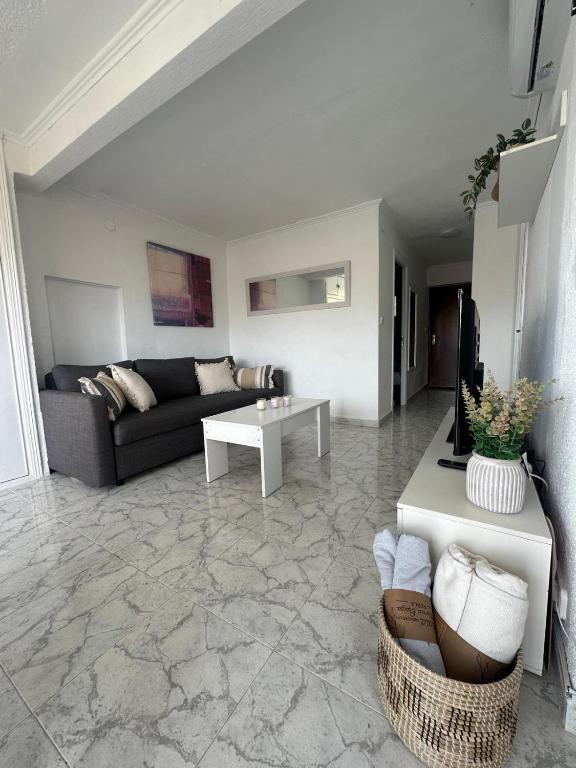 Hotel Diego suits, a living room with a couch and a table at Diego suits in Benidorm