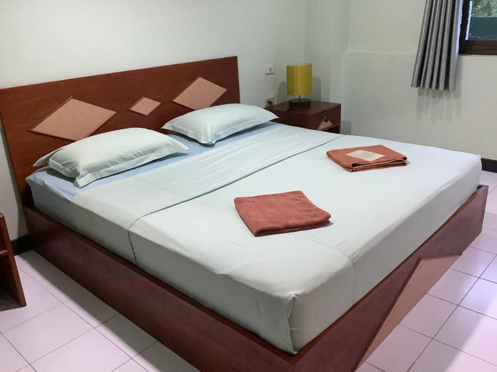 a bedroom with a large bed with two towels on it at Freedom house in Karon Beach