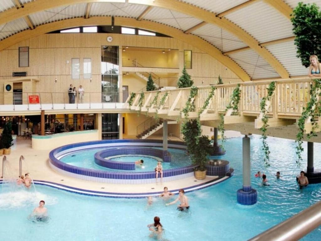 a group of people in a swimming pool in a building at Holiday home in Wernigerode with terrace in Wernigerode