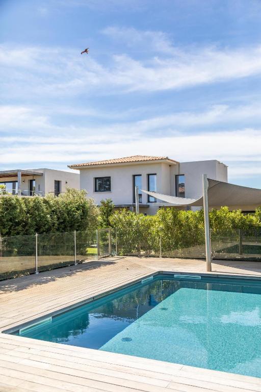 une piscine devant une maison dans l'établissement Villa Baia T3 - Kids Friendly - Clim - 900m plages St Cyprien & Cala Rossa, à Lecci