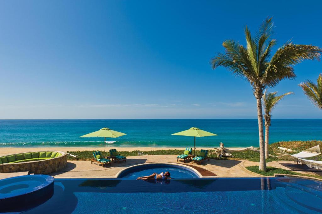 a swimming pool with the beach in the background at Villa Estero by Cabo Villas in San José del Cabo