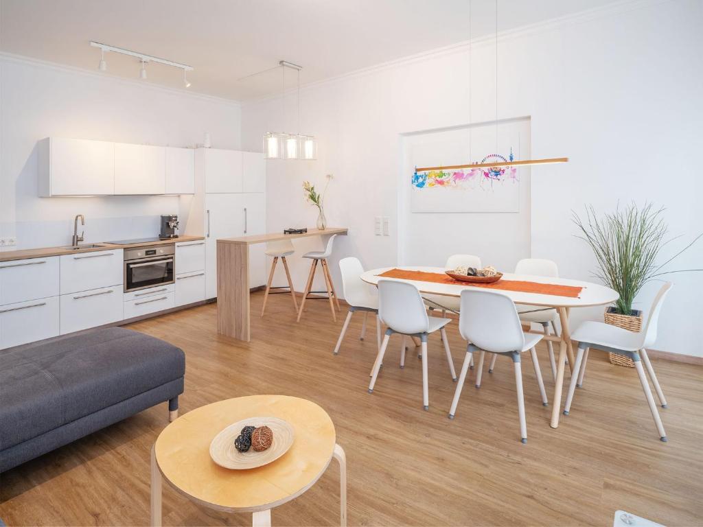een keuken en woonkamer met een tafel en stoelen bij Moderne stilvolle Wohnung im Herzen Münchens in München