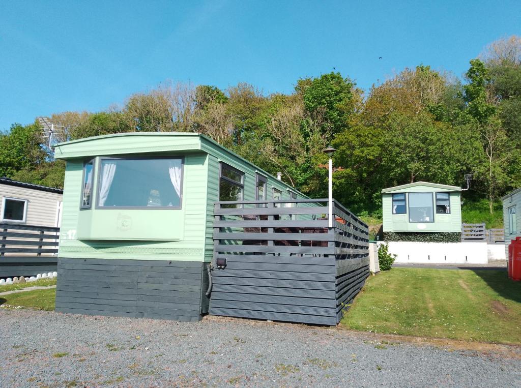 a small house sitting on the side of a yard at Cairnryan Loch View in Cairnryan