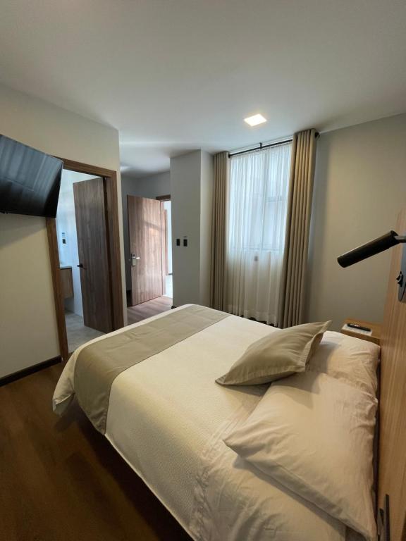 Postel nebo postele na pokoji v ubytování Universitario Hotel